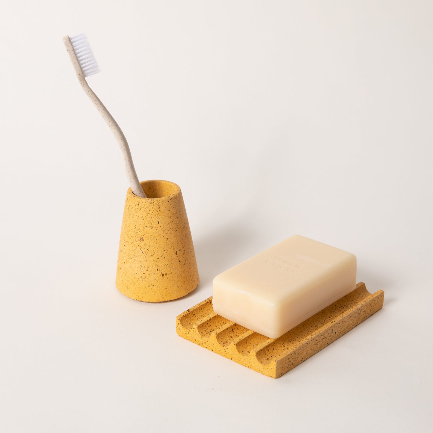 Marigold terrazzo toothbrush holder & soap dish set, styled with a toothbrush & bar of soap.