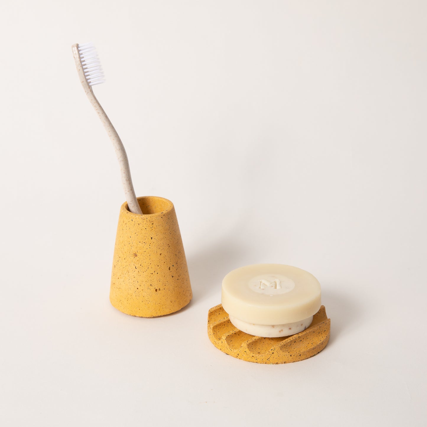 The mini soap dish & toothbrush holder set in marigold terrazzo.