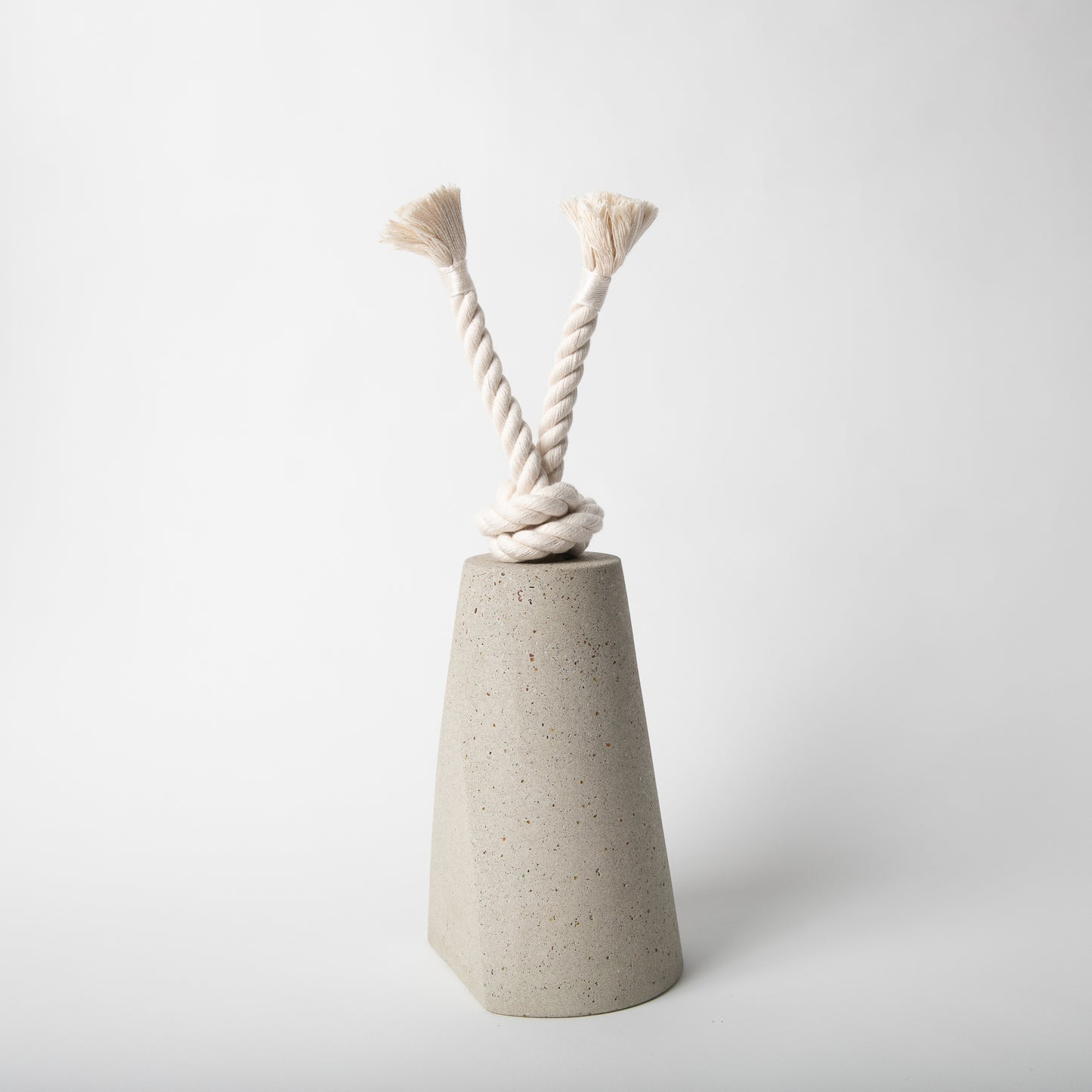 Concrete terrazzo doorstop with cotton rope in natural.