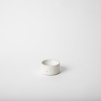 Round terrazzo concrete incense holder in white.