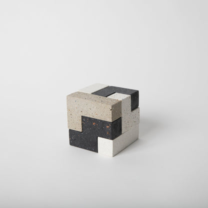 Concrete soma cube desk puzzle put together.