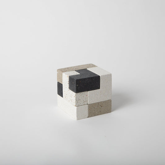 Concrete soma cube desk puzzle put together.