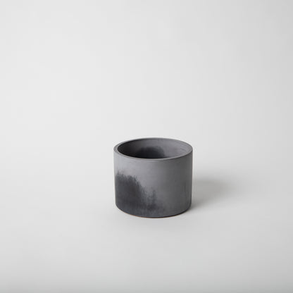 4 inch concrete vessel with cork base in black and grey.