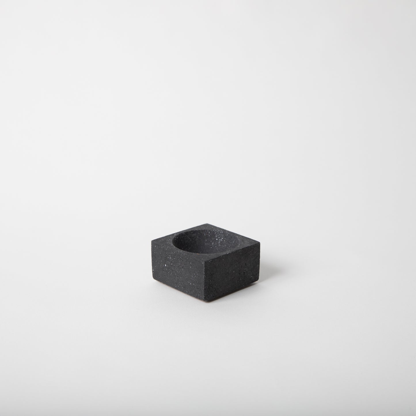 Square concrete terrazzo incense holder in black.