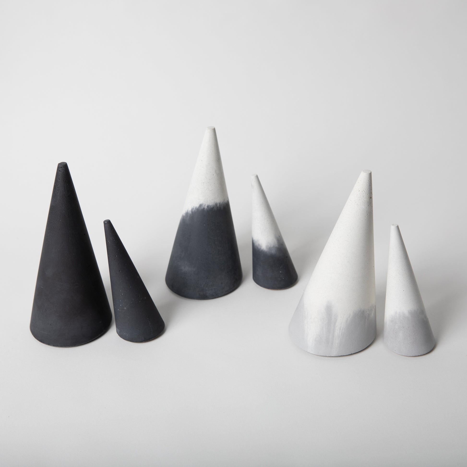 Cone shaped concrete jewelry holder with cork base in various colors.