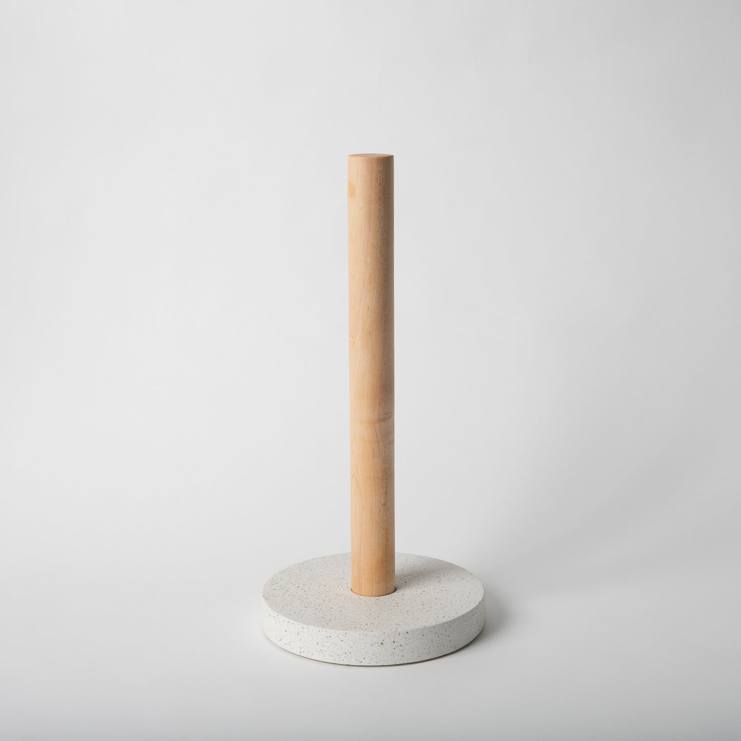 Concrete terrazzo paper towel holder in white terrazzo with maple rod.