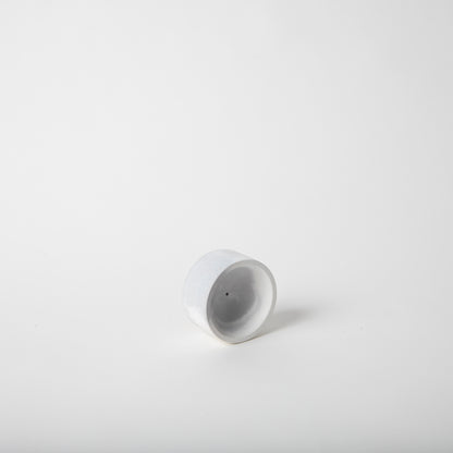 Round concrete incense holder in grey and white,