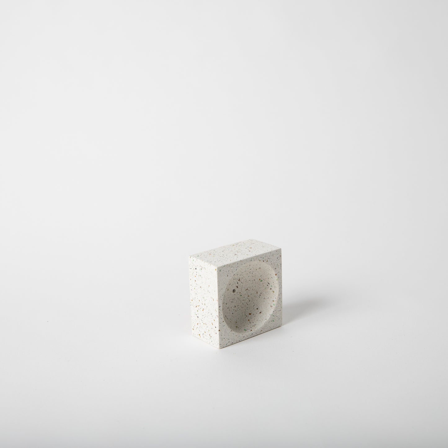 Square concrete terrazzo incense holder in white.