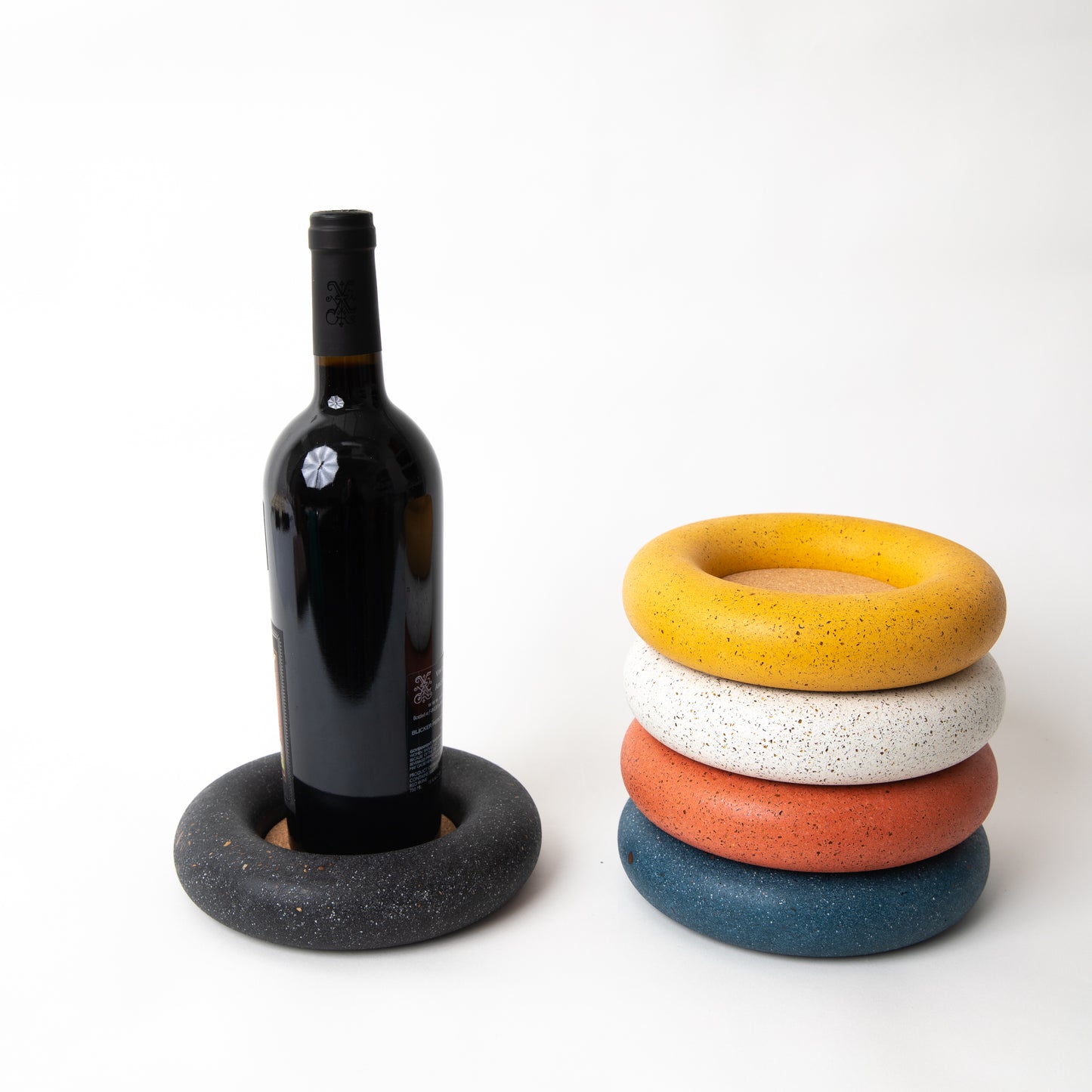 Concrete terrazzo wine bottle coaster in various colors.
