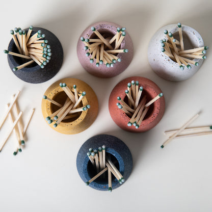 Concrete terrazzo matchstick holder in various colors with matchsticks.