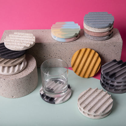 Terrazzo concrete coasters in a neutral color set of 4. Seen amongst other color sets.